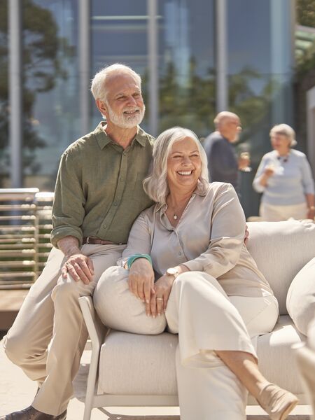 Couple sitting on couch at The Baytree