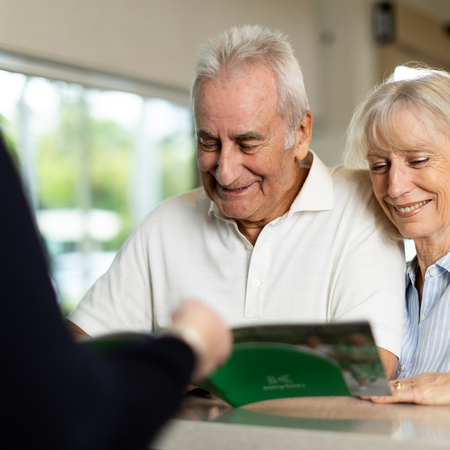 Senior couple looking at a Keyton brochure