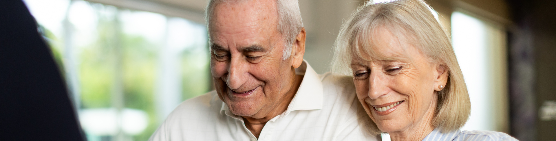 Senior couple looking at a Keyton brochure