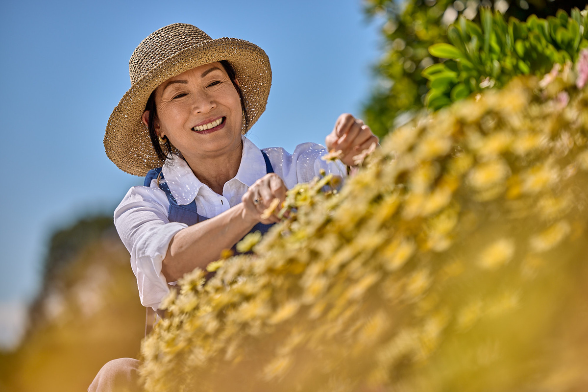Happy woman tending flowers