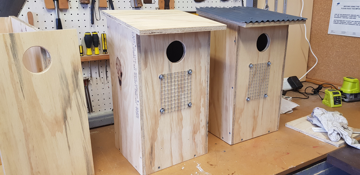 Homemade bird boxes on display in a workshop