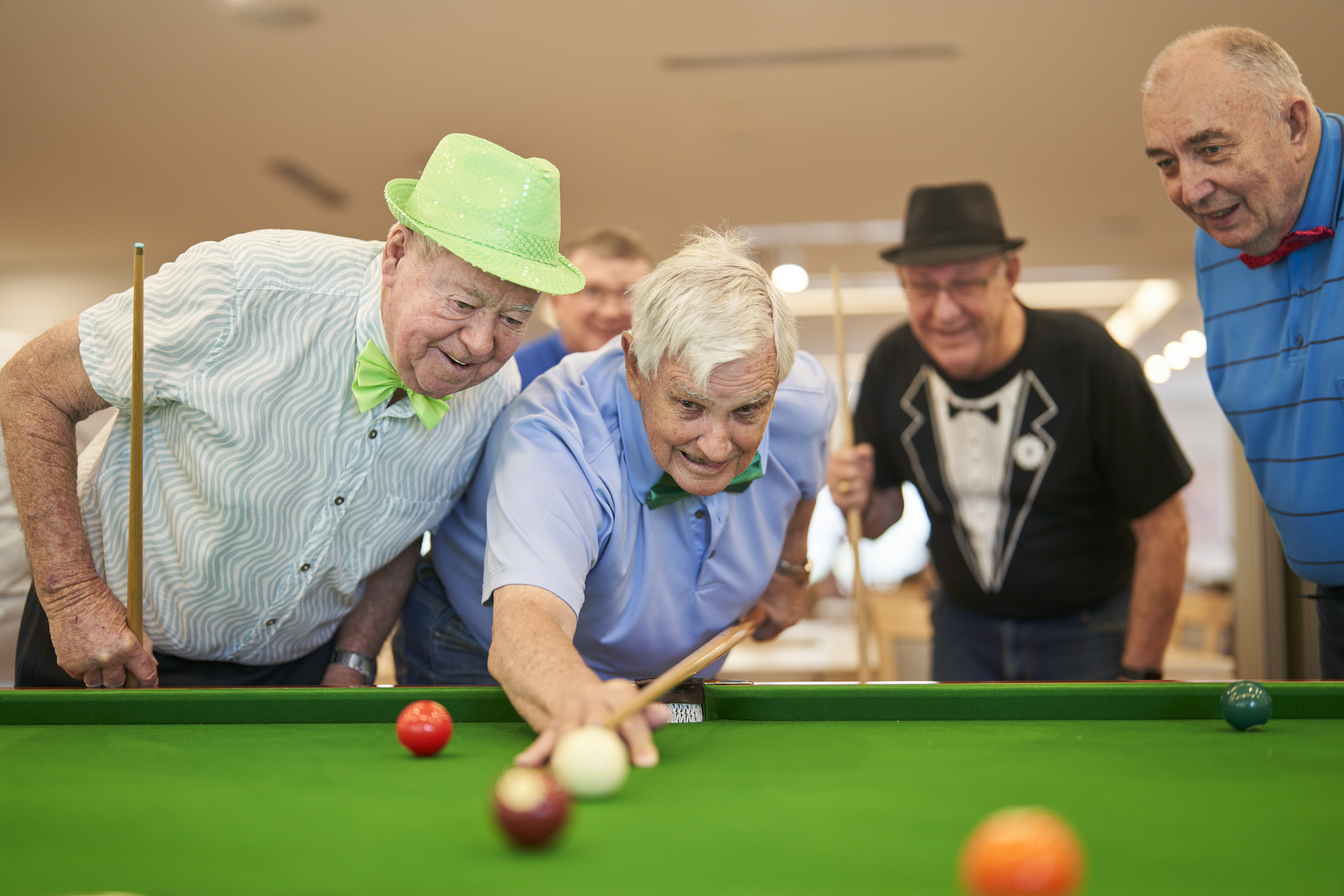 a group of seniors playing pool