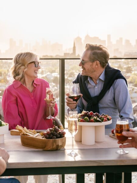 An elderly couple smiling and enjoying views of Melbourne