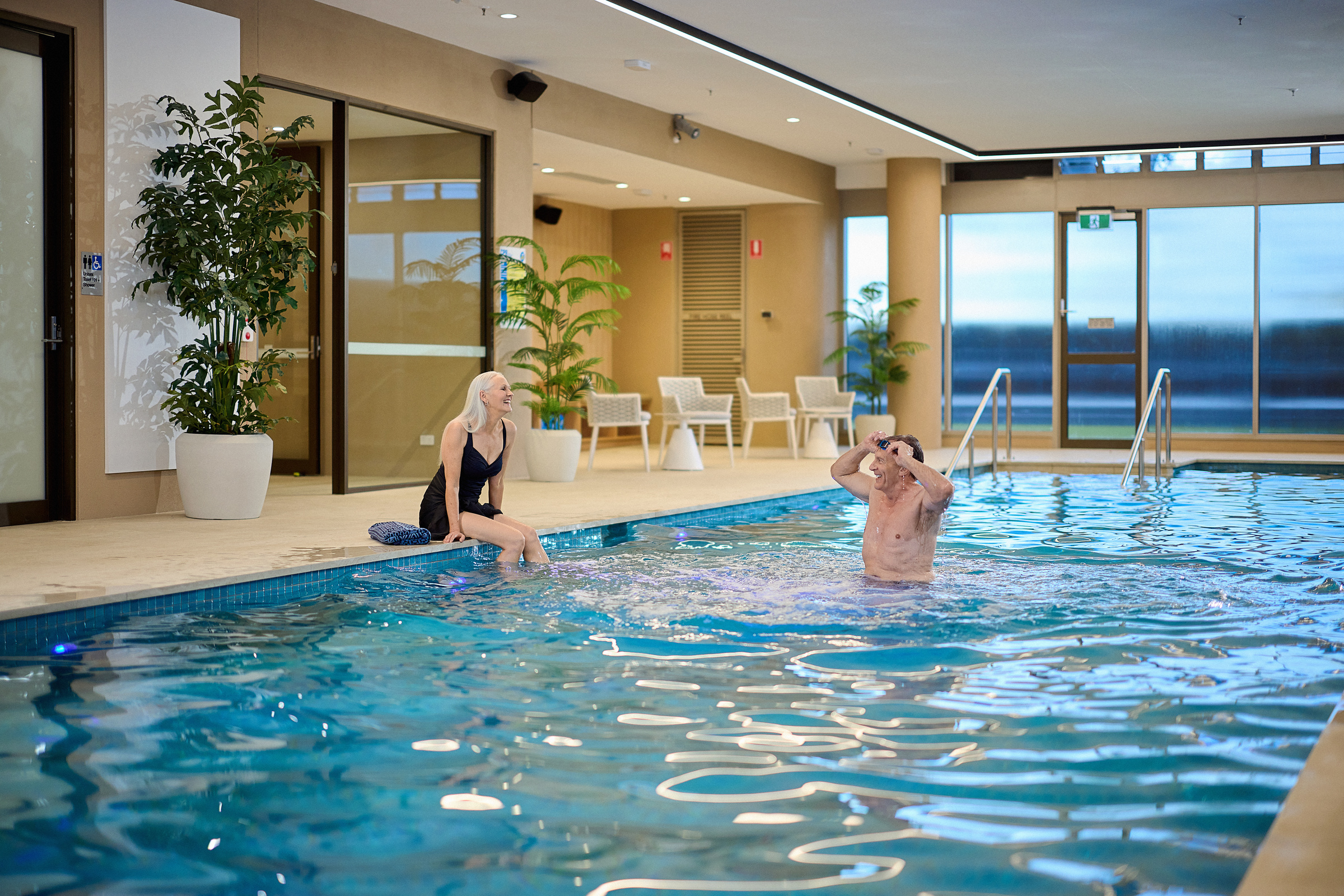 Couple at the indoor heated pool at Poinciana House