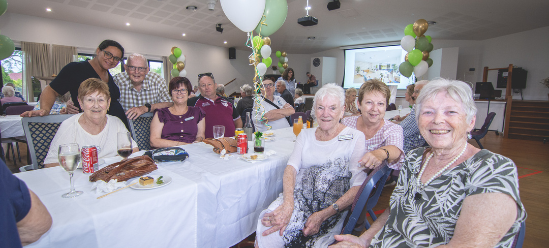 Residents of The Gardens on Lindfield  seated together at the community centre reopening event.