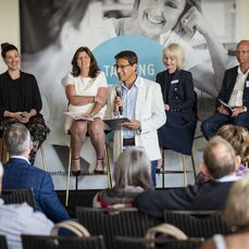 Andrew Winter from Selling Houses Australia is standing in front of a panel of 4 other experts at our Talking Retirement Living masterclass. 