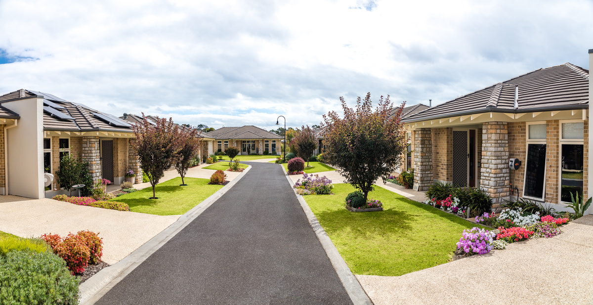 Martha's Point tree lined road amongst well maintained gardens and lawns