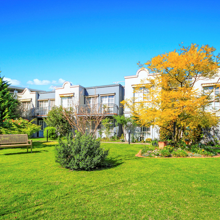 Lexington Gardens landscape and gardens with bench seating amongst buildings