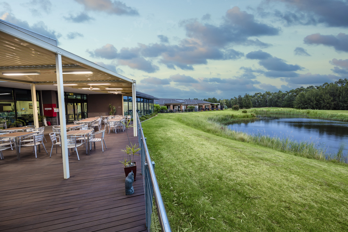 Waterford Park covered outdoor terrace with seating overlooking golf lake