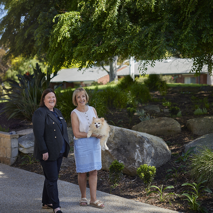Village Manager Leanne and a resident with a dog