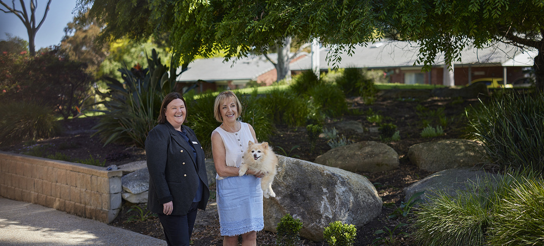 Village Manager Leanne and a resident with a dog