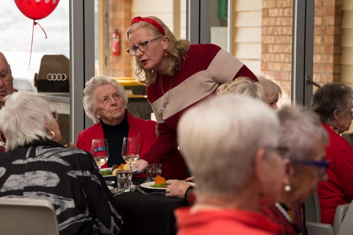 Receptionist Karen speaking to a resident at the Abervale retirement village anniversary