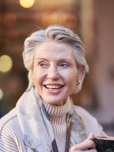 Older woman enjoys coffee