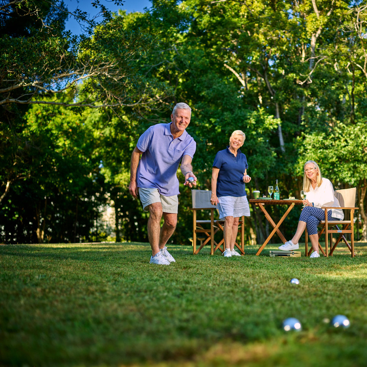 Group of retirees doing bowls and enjoying a glass of wine in the afternoon