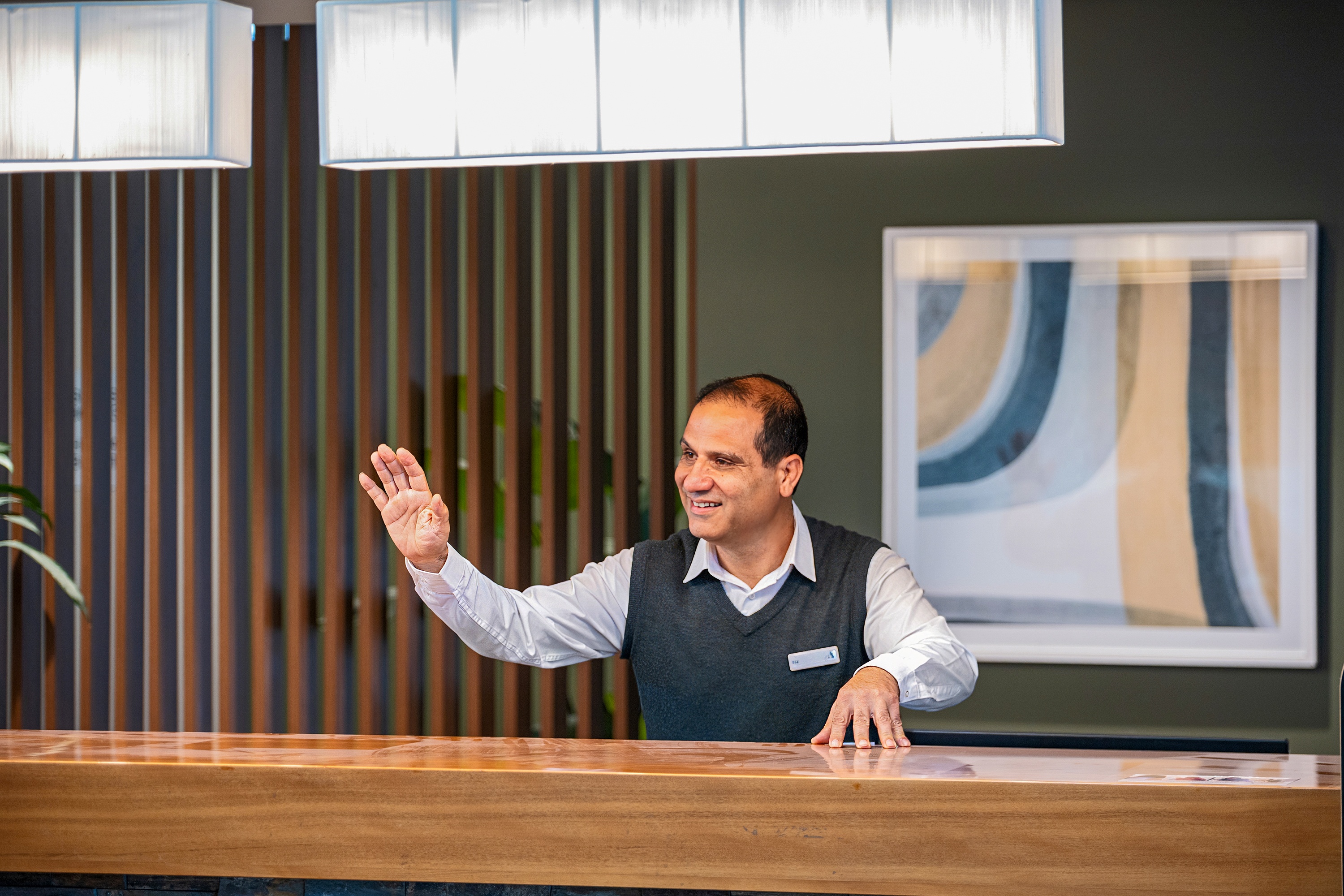 Concierge Kaz waving at The Baytree