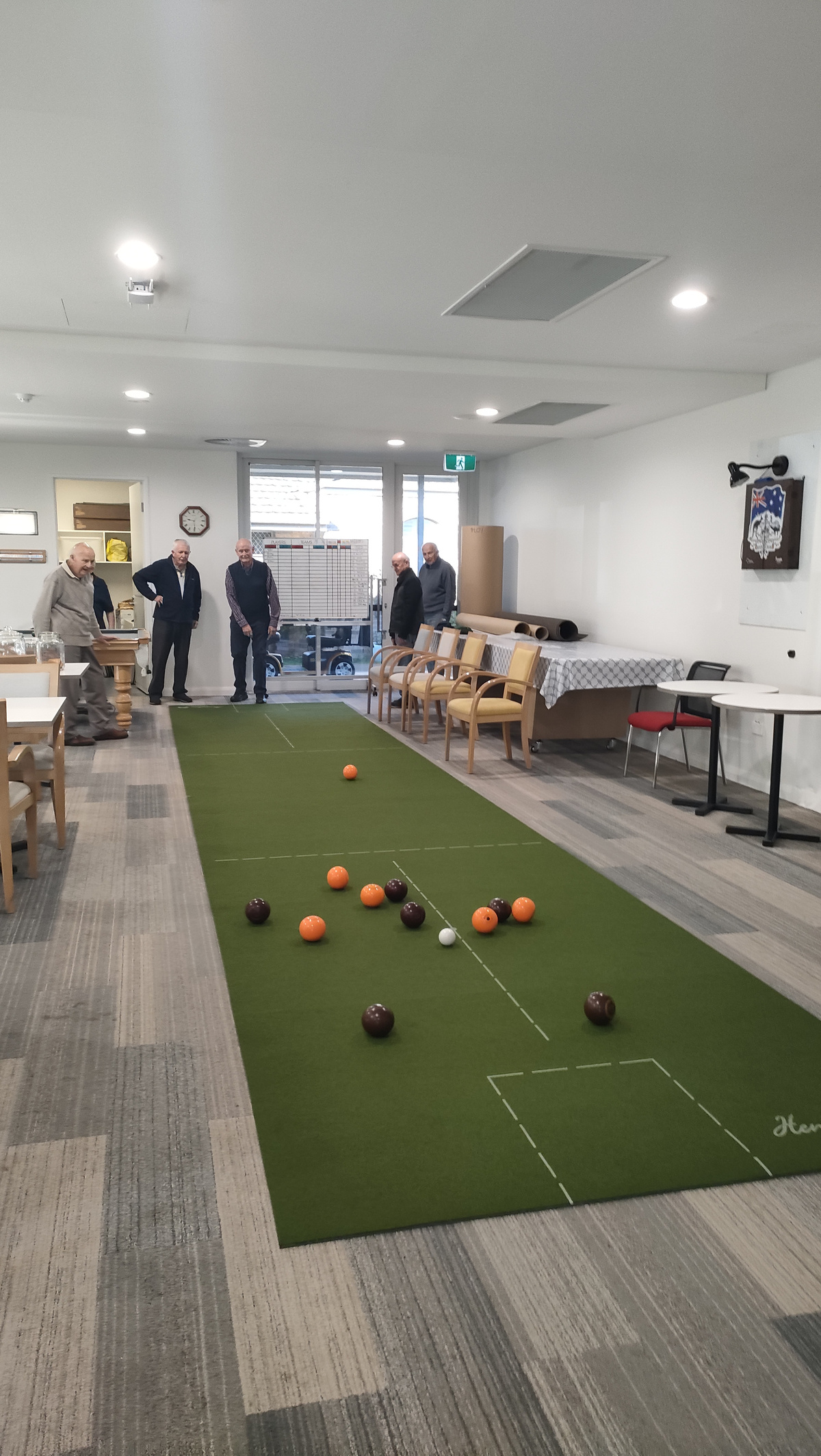 Residents enjoying their new carpet bowls mat