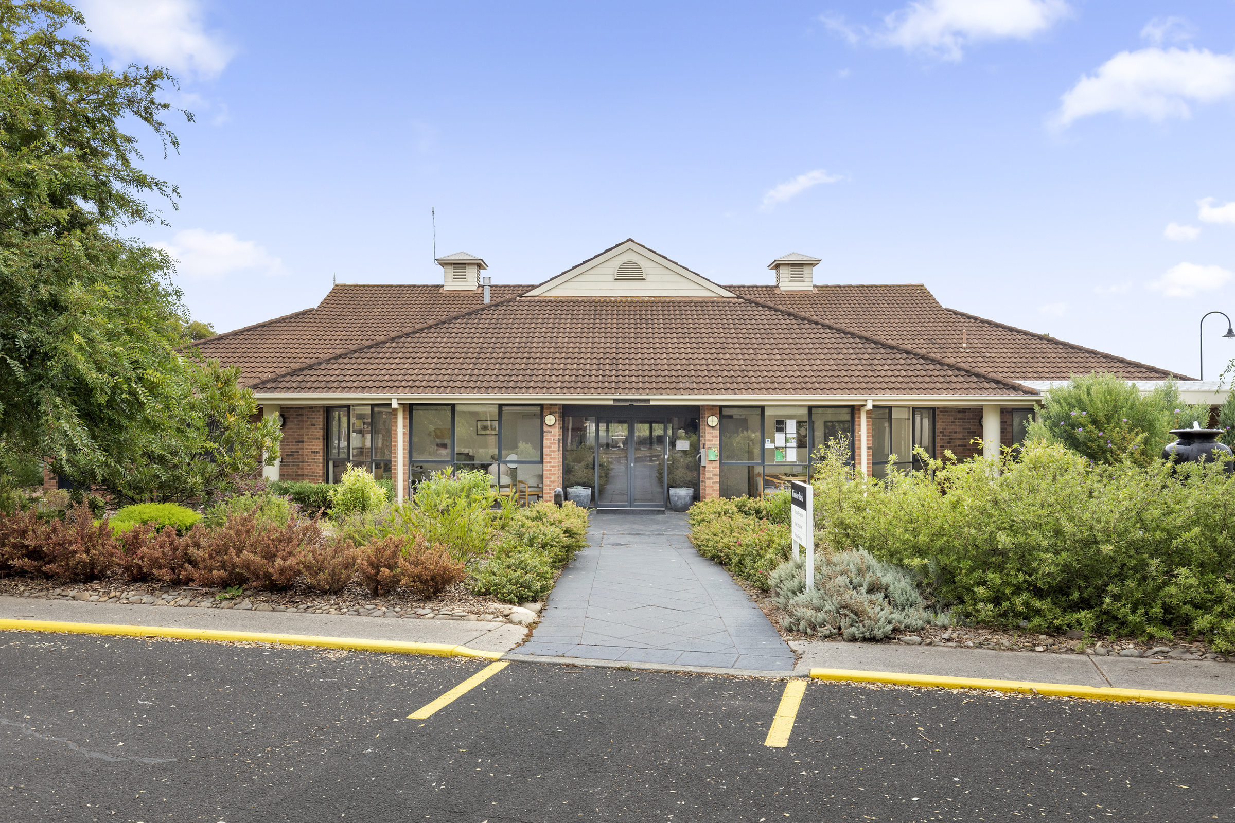 Windsor Park image of landscaping and main entrance to building