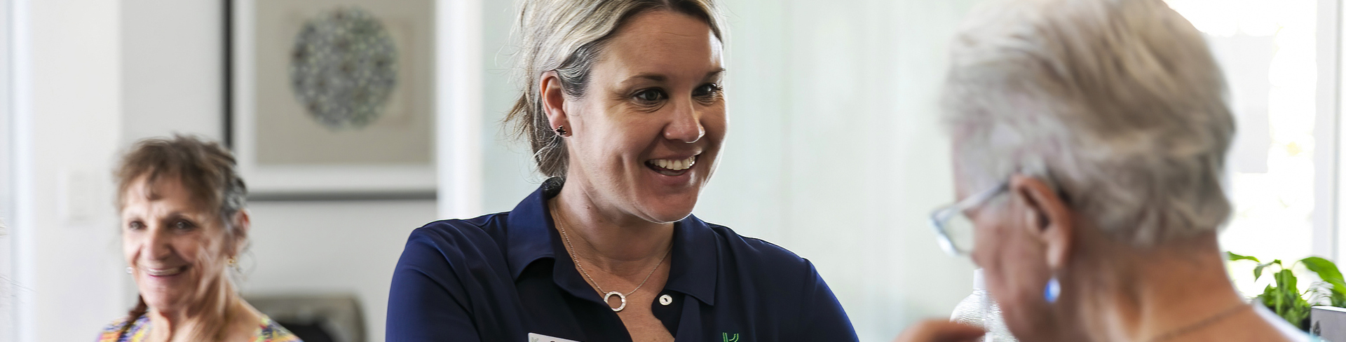 A female Keyton staff member holding a box for an elderly female resident