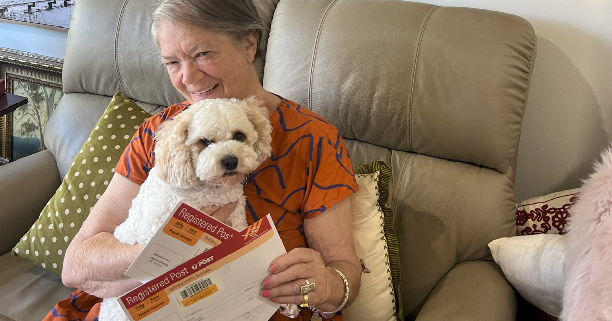 Resident  Annabel with her puppy holding two letters ready to be delivered