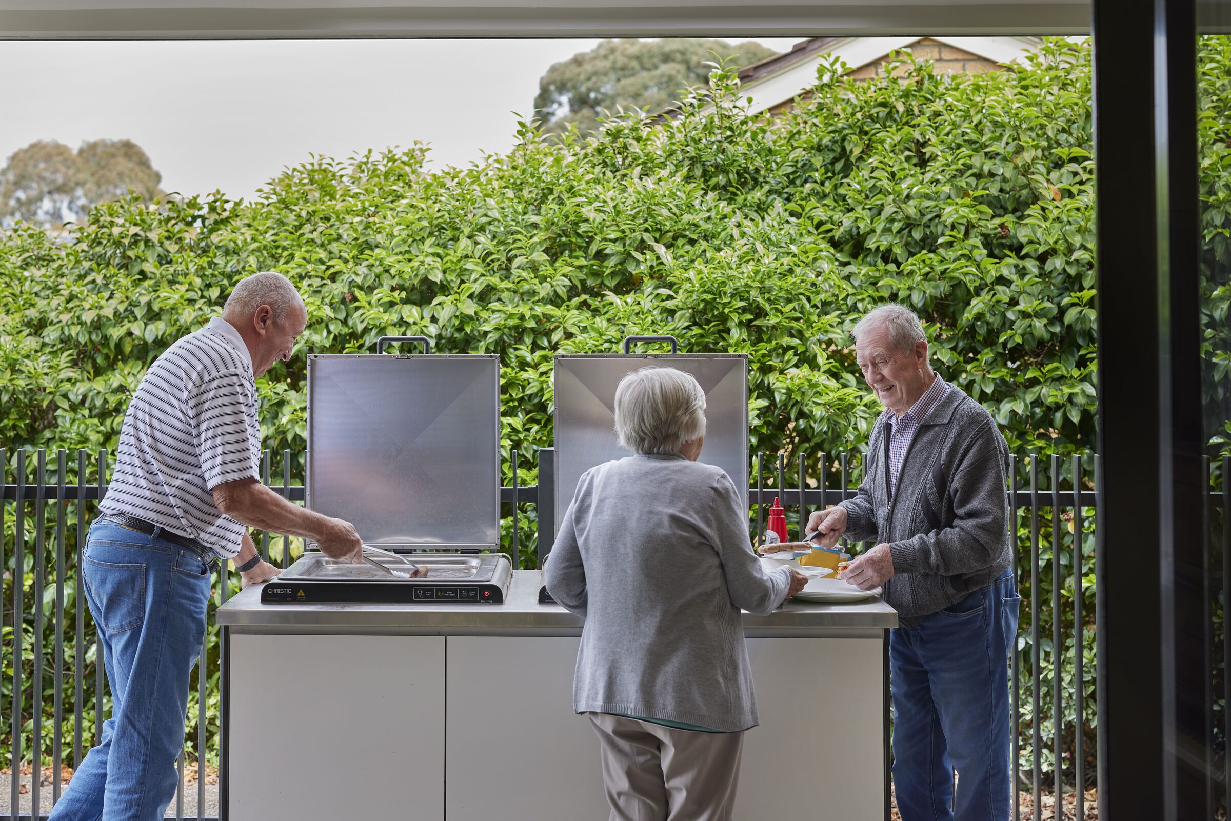 Viewbank Gardens residents chatting over a BBQ