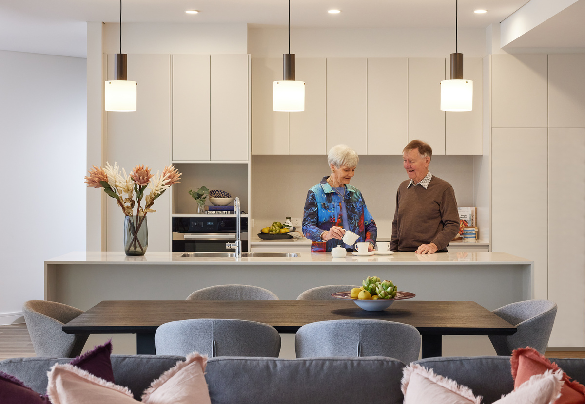 Menzies Malvern apartment kitchen with couple preparing beverages