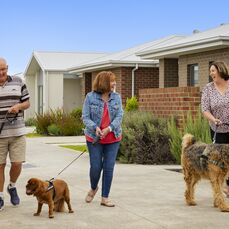 Three Sherwin Rise residents walking their dogs together in the retirement village