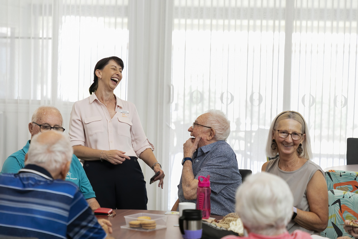 A hair artist touching up an old lady's hair