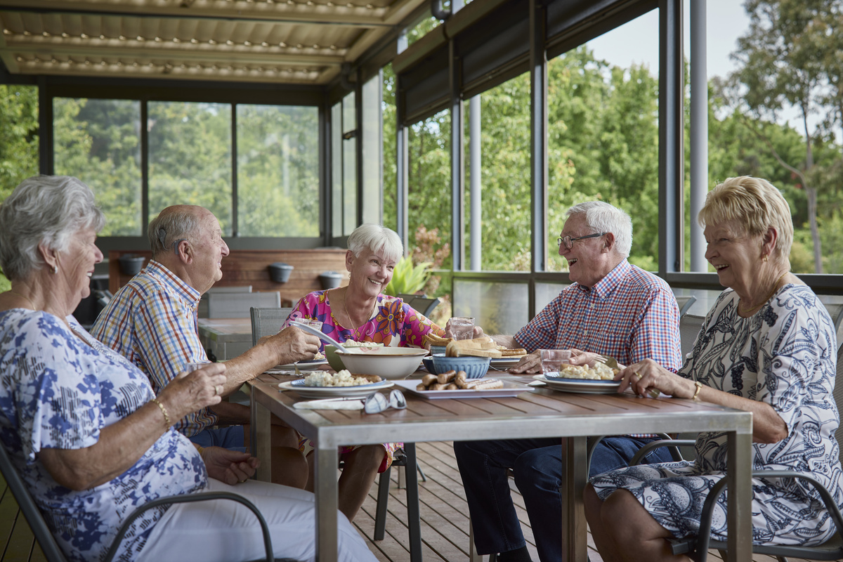 Reisdents enjoying a BBQ lunch in the alfresco area