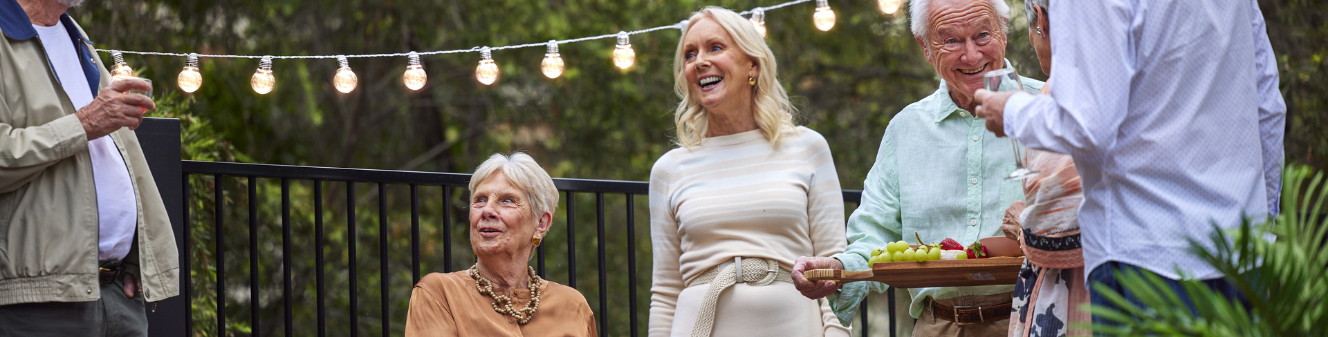 A group of retirement village residents socialising together at happy hour.