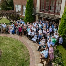 All the staff and residents pose in front of the retirement village