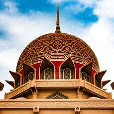 A decorative red and gold temple dome roof is one of the many places to explore while travelling alone in Malaysia