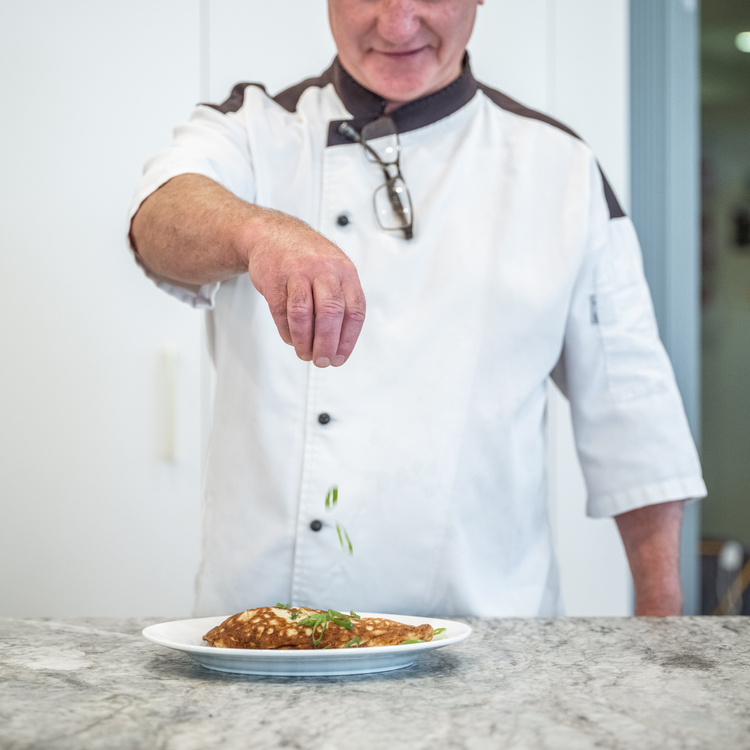 Ardency Aroona head chef Colin sprinkling garnish on a delicious meal