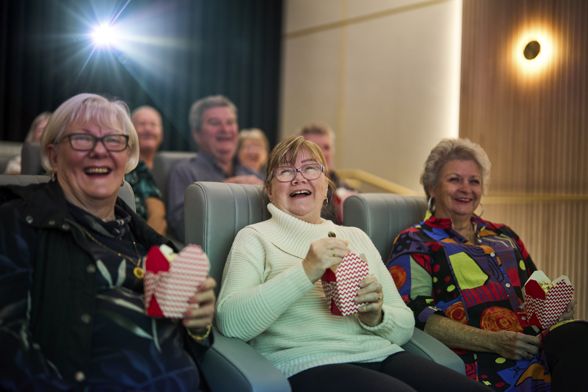Kingfisher Grove Village Residents enjoying a movie in the theatre 