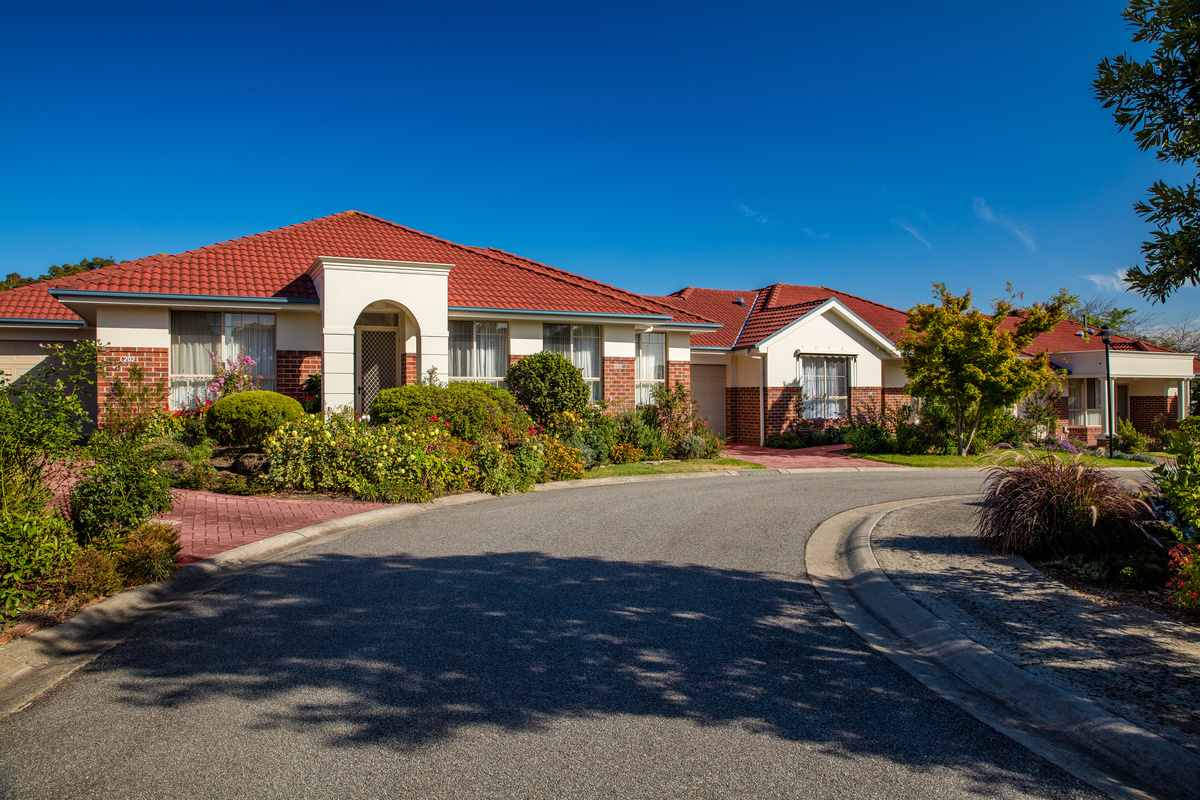Peppertree Hill village roadway lined with homes, trees and lovely gardens
