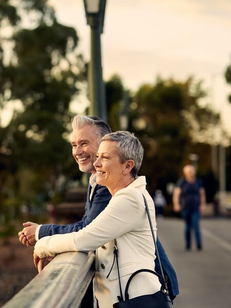 An elderly couple smiling and enjoying views of Melbourne