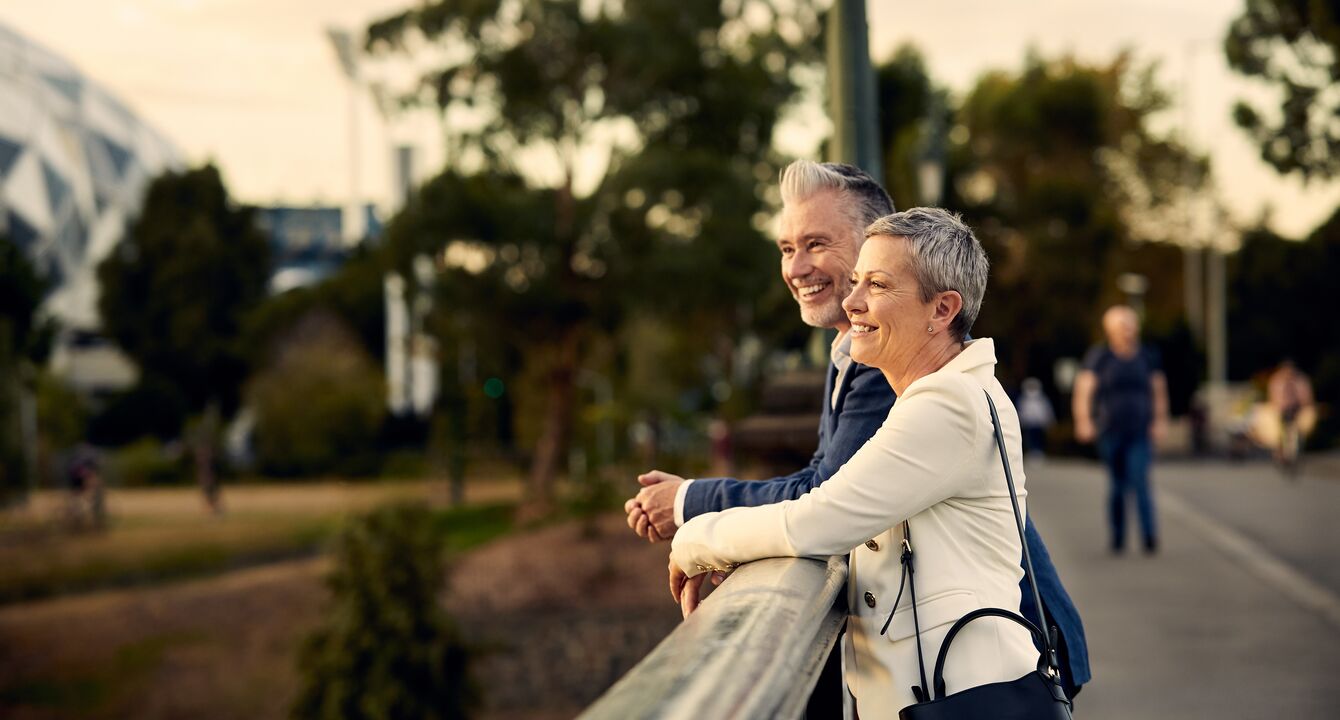 An elderly couple smiling and enjoying views of Melbourne