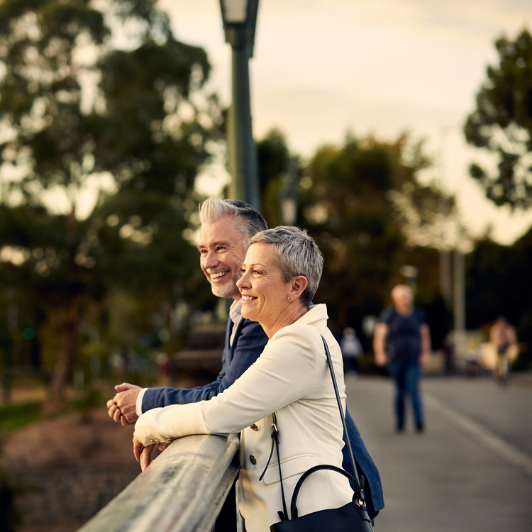 An elderly couple smiling and enjoying views of Melbourne