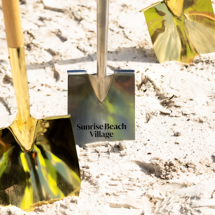 Four shovels in sand