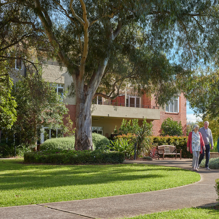 Classic Residences Brighton people walking in landscaped gardens building in background