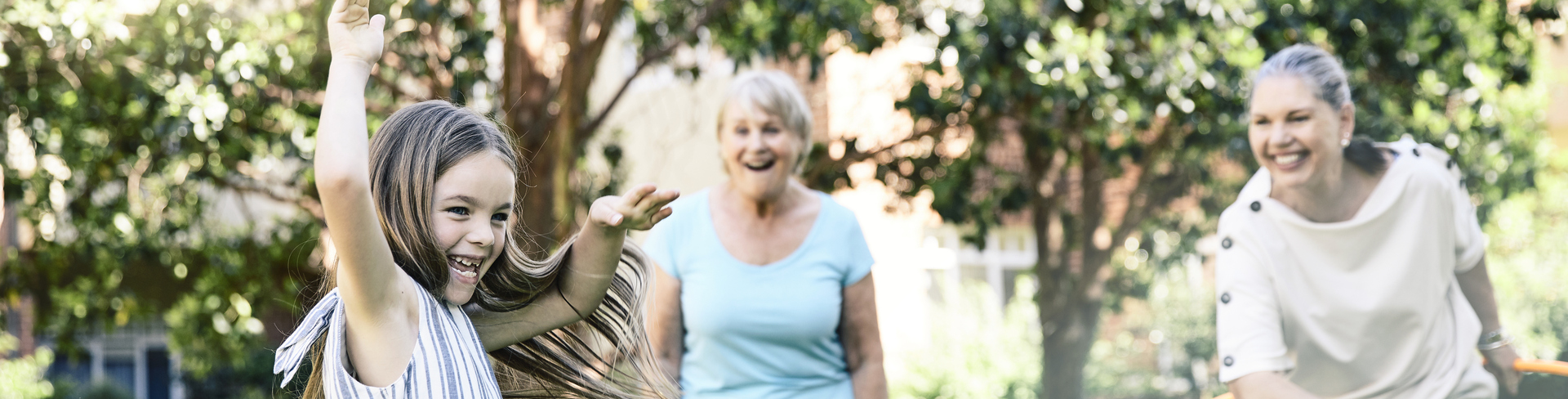 Family having fun playing hula hoop with granddaughter