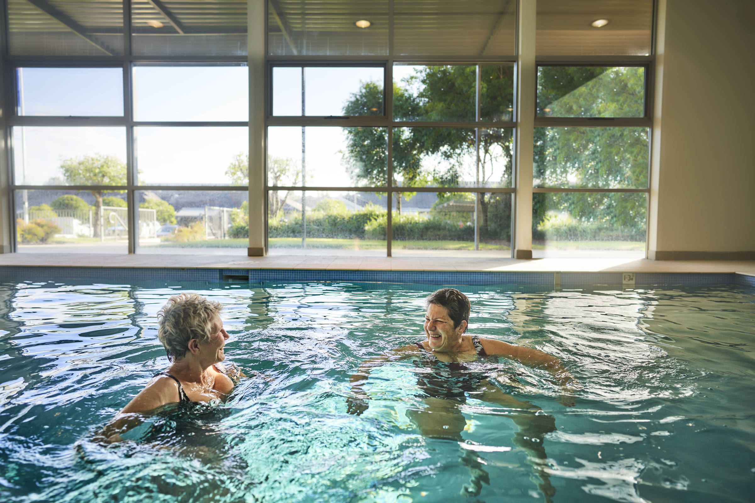 Rochford Place residents swimming in the indoor heated swimming pool relaxing