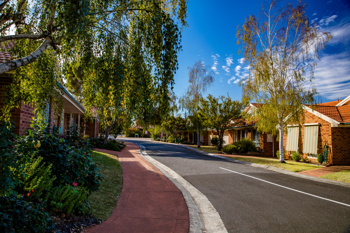 Fiddlers Green road lined by houses, gardens and trees