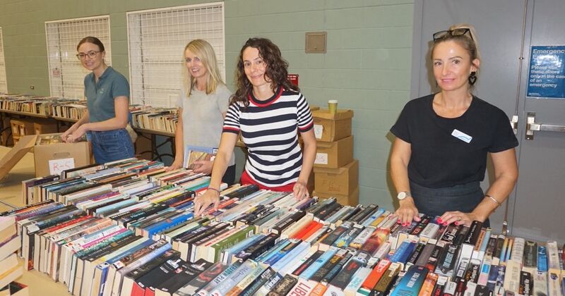 Four women sorting books