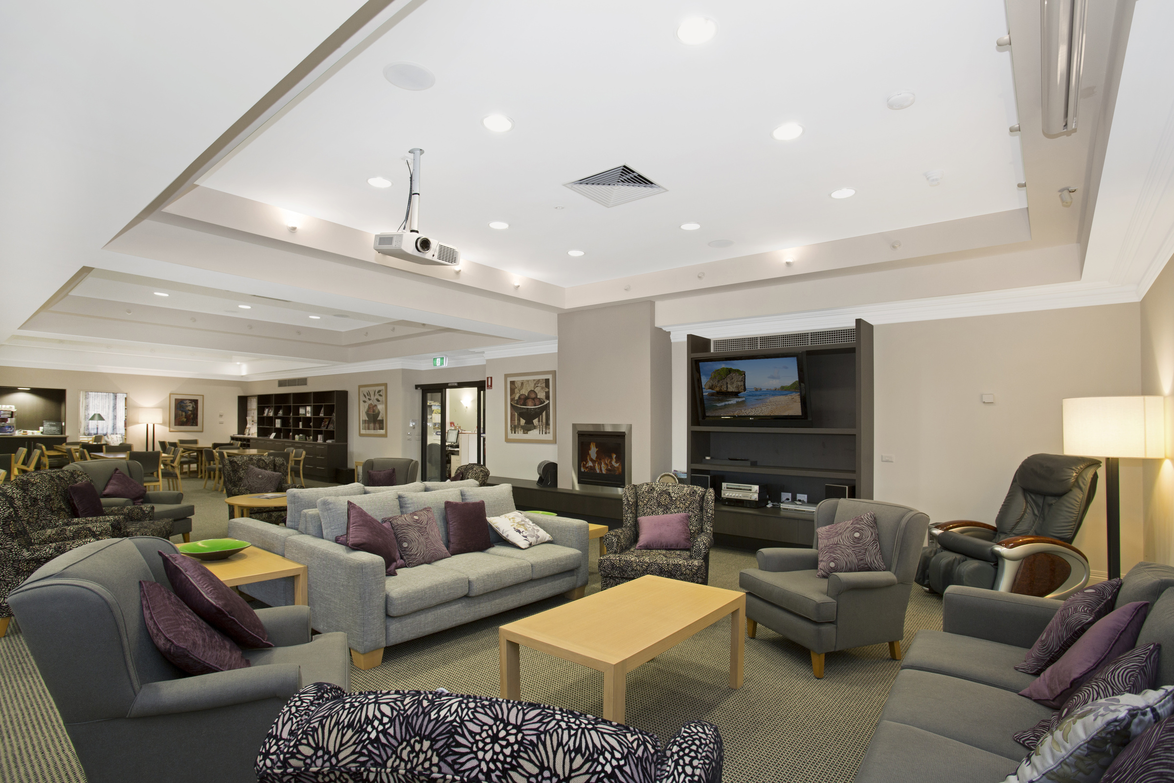 Windsor Park spacious lounge area with seating, fireplace and television