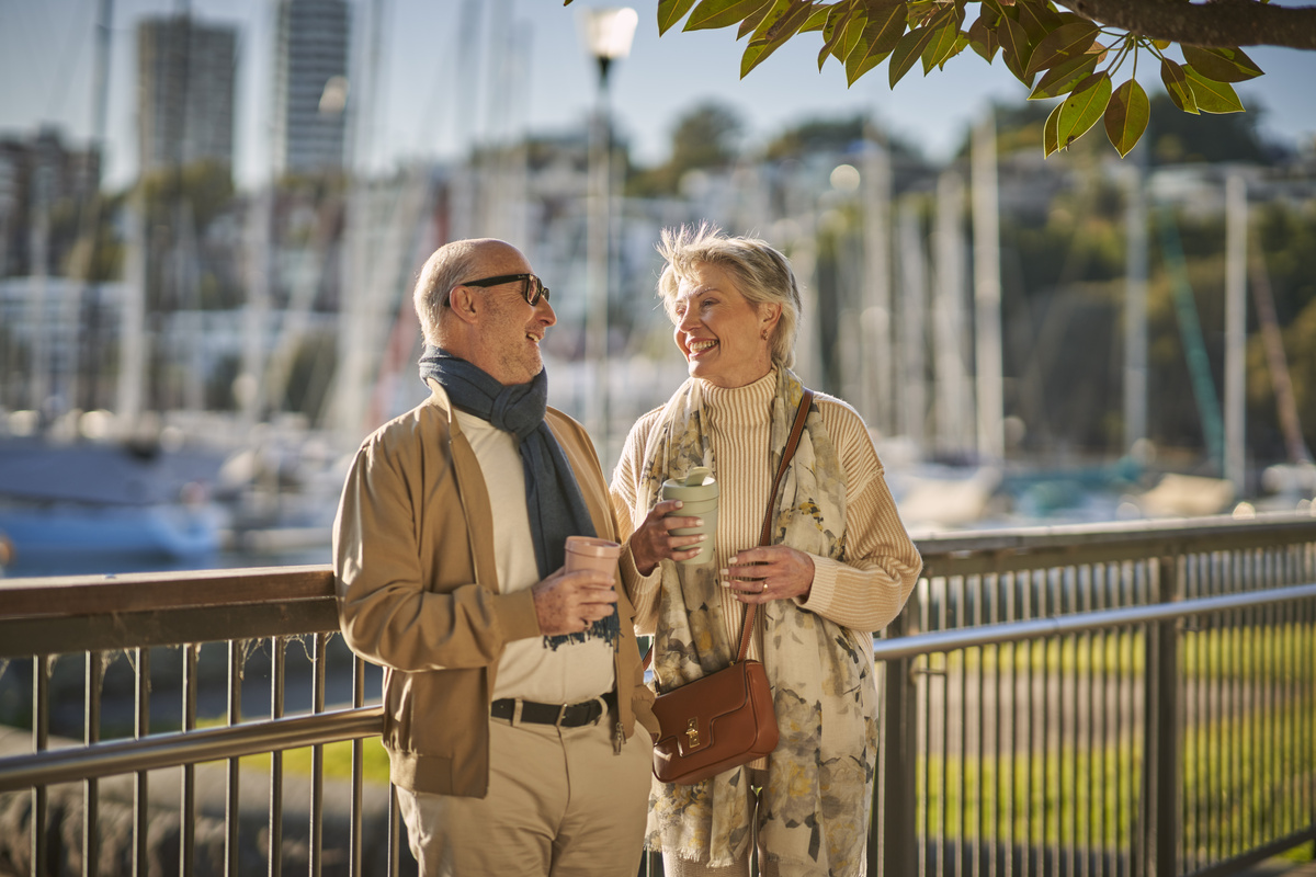 A couple laughing beside the harbour