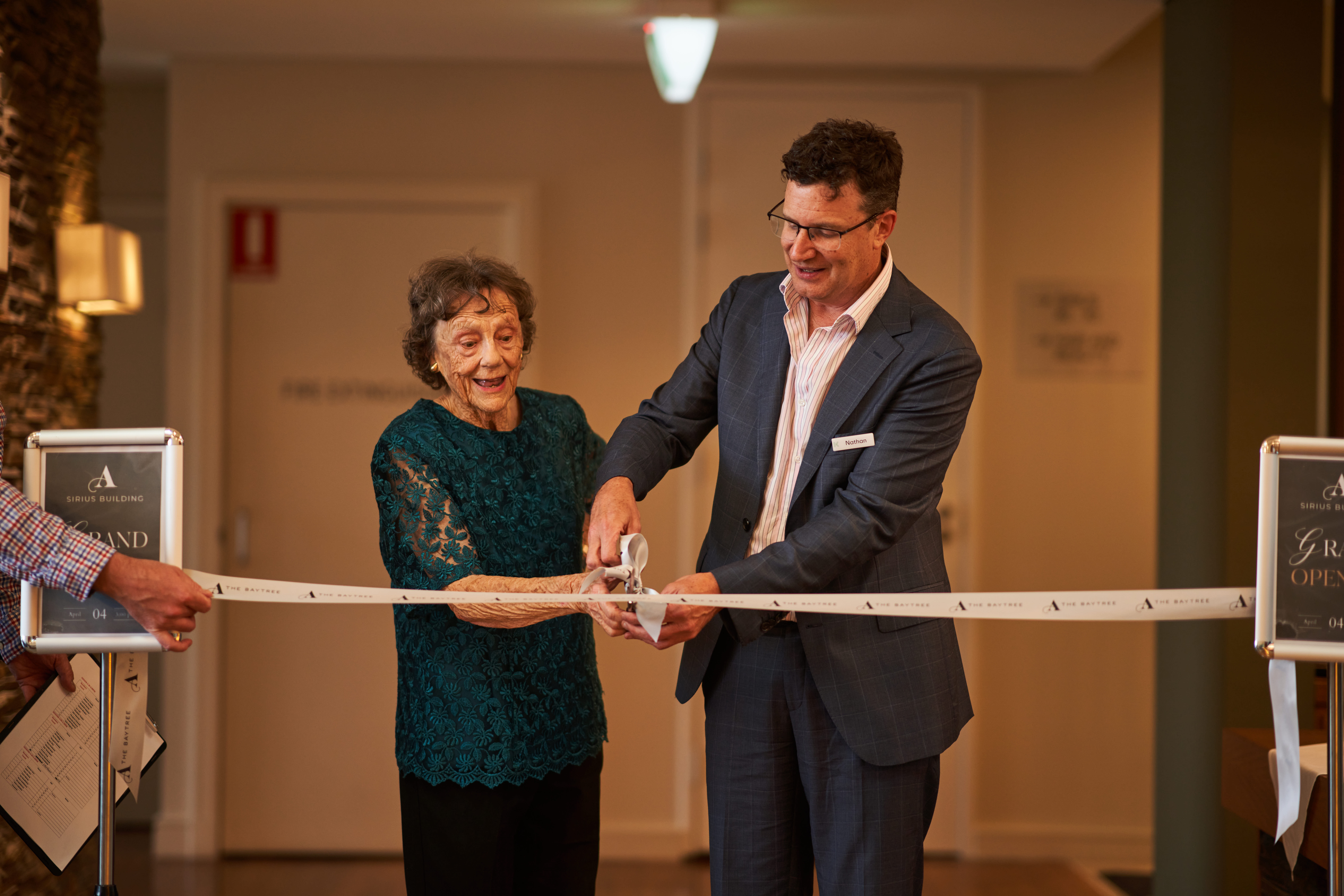 Keyton CEO Nathan Cockerill and resident Jean cutting the ribbon at the Grand Opening of the Sirius Building at The Baytree by Ardency