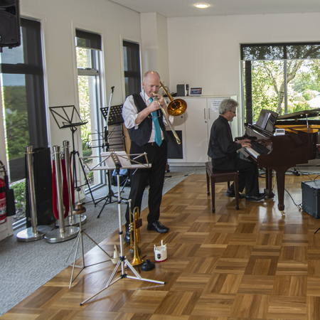 A group of musicians performing in the community hall at the Coastal Waters retirement village