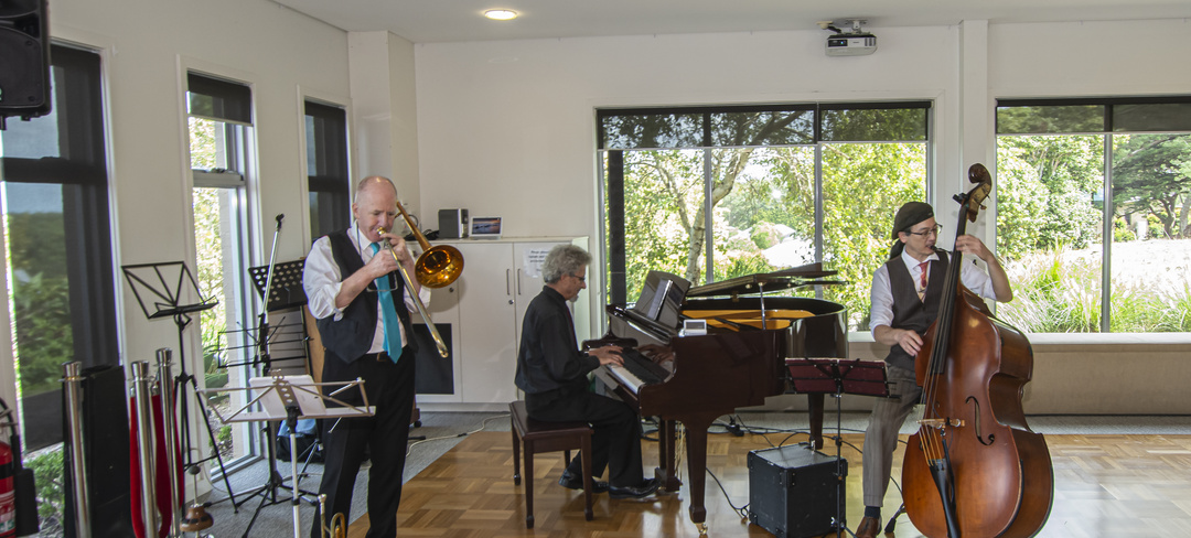 A group of musicians performing in the community hall at the Coastal Waters retirement village