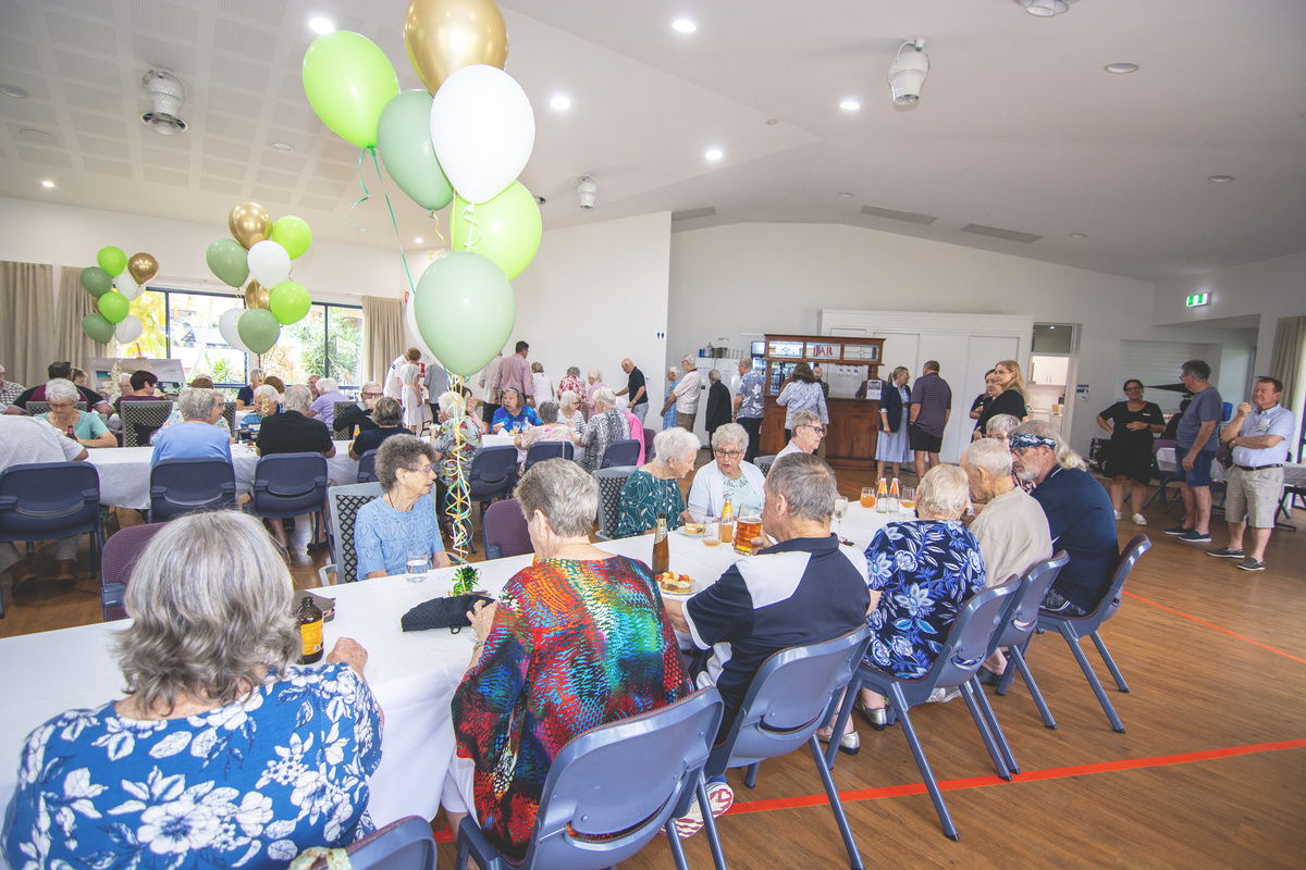 Residents of The Gardens on Linfield  seated together at the community centre reopening event.