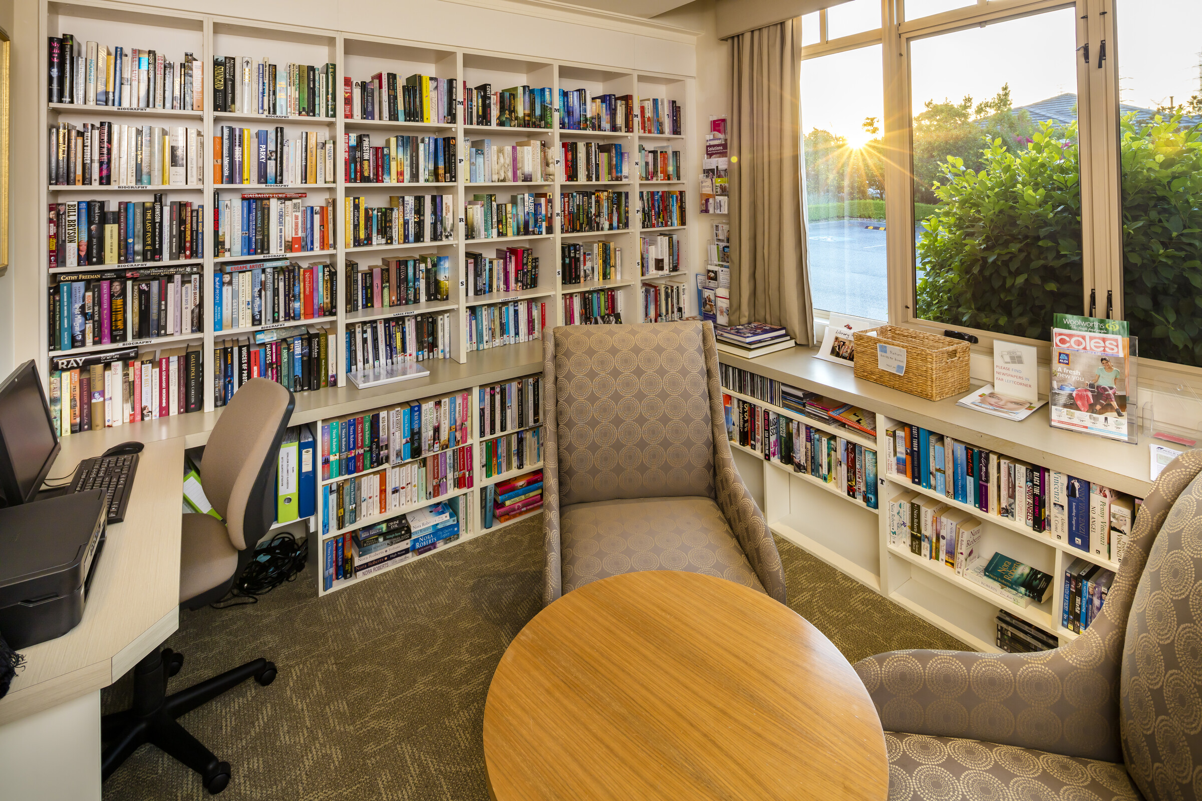 Waverley Country Club library room with well stocked bookcases, computer at desk and seating